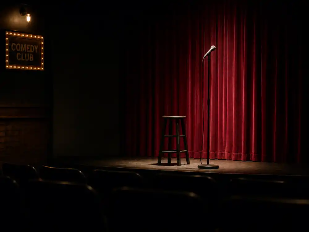 Comedy club stage reflecting how old is Kevin Hart career arc from Philadelphia open-mic nights to arena stand-up tours and blockbuster film stardom
