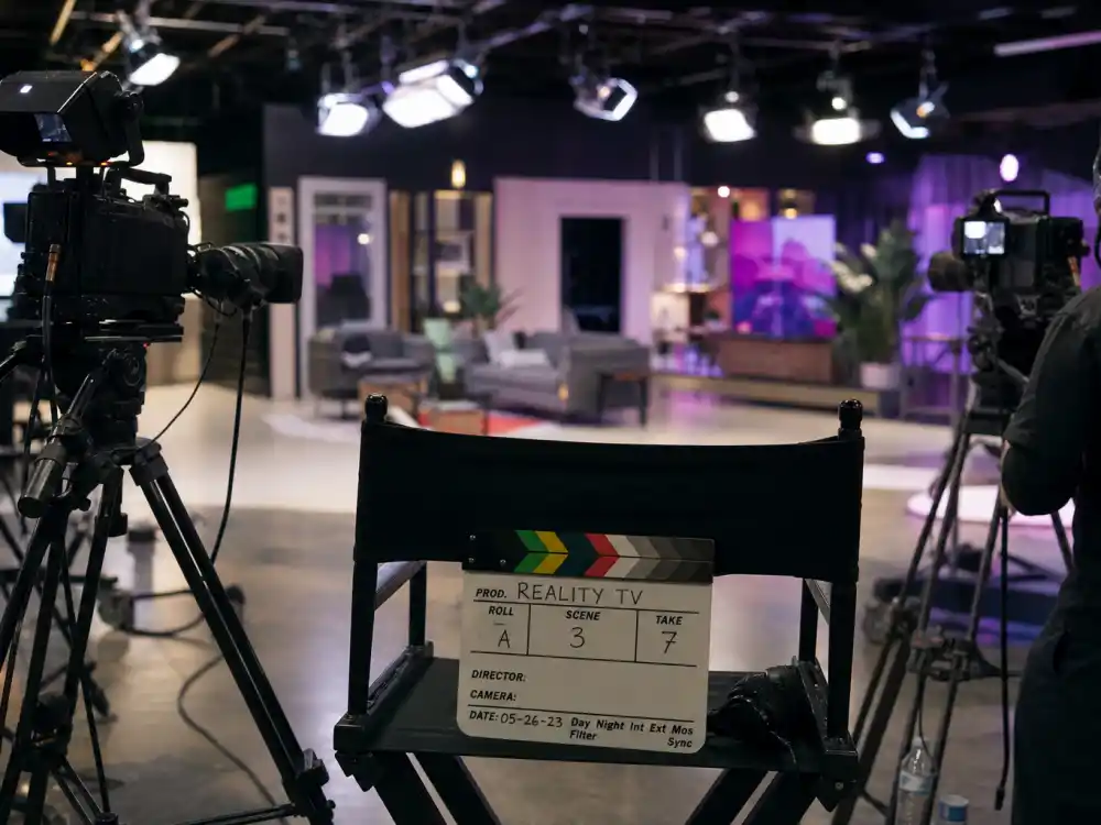 Reality television studio with cameras reflecting how old is Kourtney Kardashian career arc from family docuseries breakout to lifestyle and wellness empire