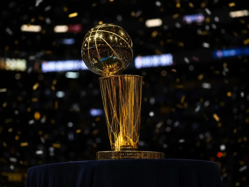 NBA championship trophy display reflecting how old is LeBron James at industry peak — four titles, Olympic gold, and all-time scoring record in his forties