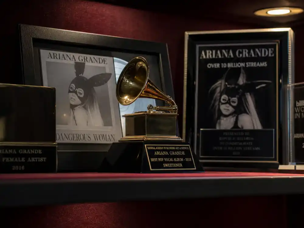 Grammy award trophy display reflecting how old is Lizzo at her industry peak — chart-topping albums and historic Grammy wins in her early thirties