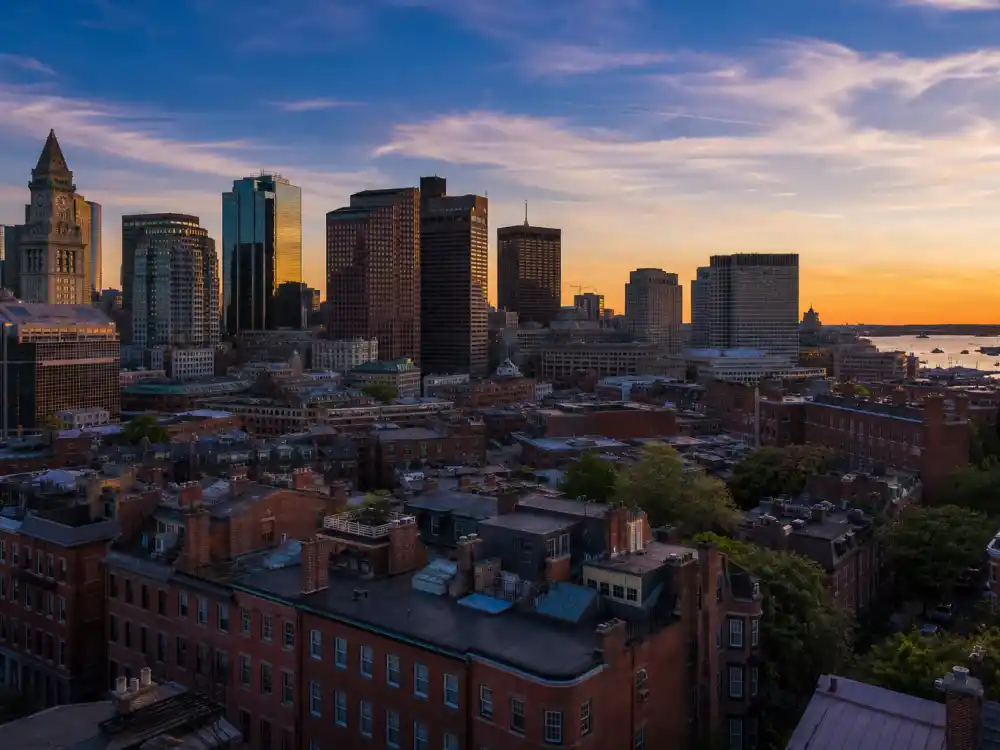 Boston Massachusetts skyline evoking how old is Mark Wahlberg birthplace — the city where Mark Robert Michael Wahlberg was born on June 5, 1971