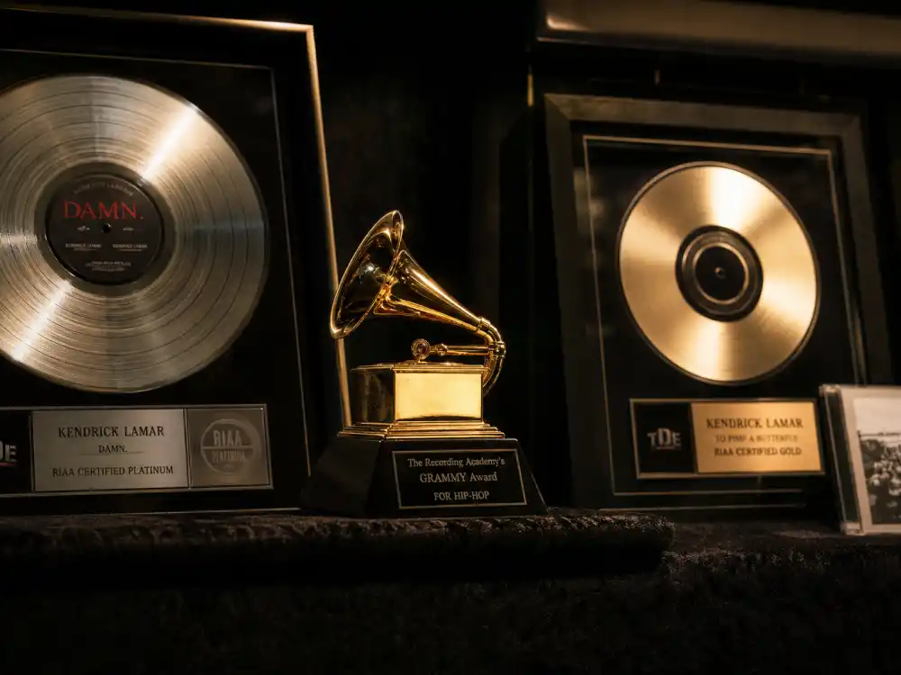 Music industry award trophy display reflecting how old is Megan Thee Stallion at her industry peak — chart-topping albums and Grammy-winning milestones in her twenties
