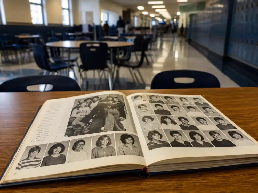 High school yearbook on cafeteria table reflecting how old is Olivia Rodrigo teen years before Disney series and breakout pop stardom