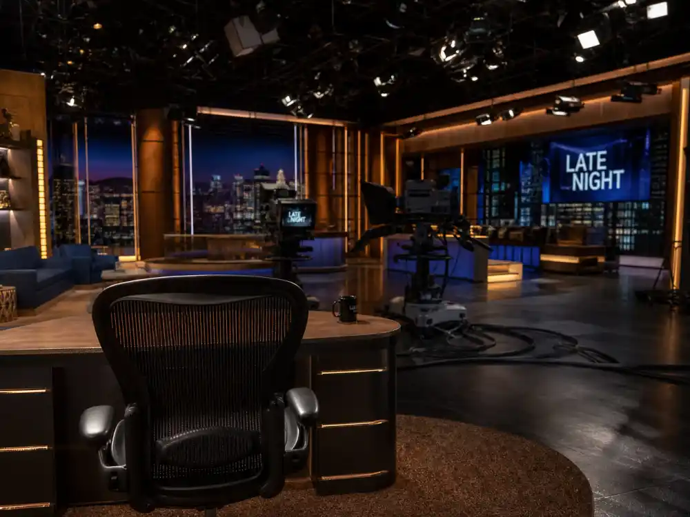 Television talk show studio set reflecting how old is Oprah Winfrey career arc from local news anchor to syndicated daytime icon and media mogul