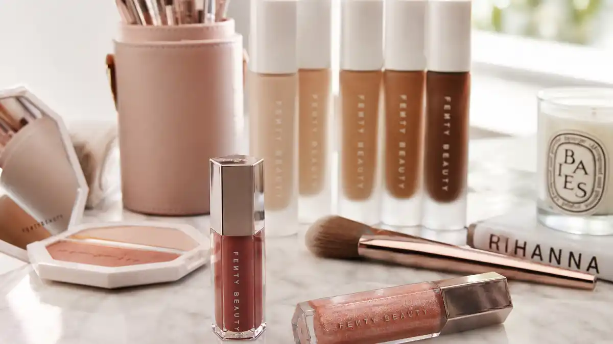 How old is Rihanna editorial hero — Fenty Beauty products on marble vanity without identifiable Rihanna likeness