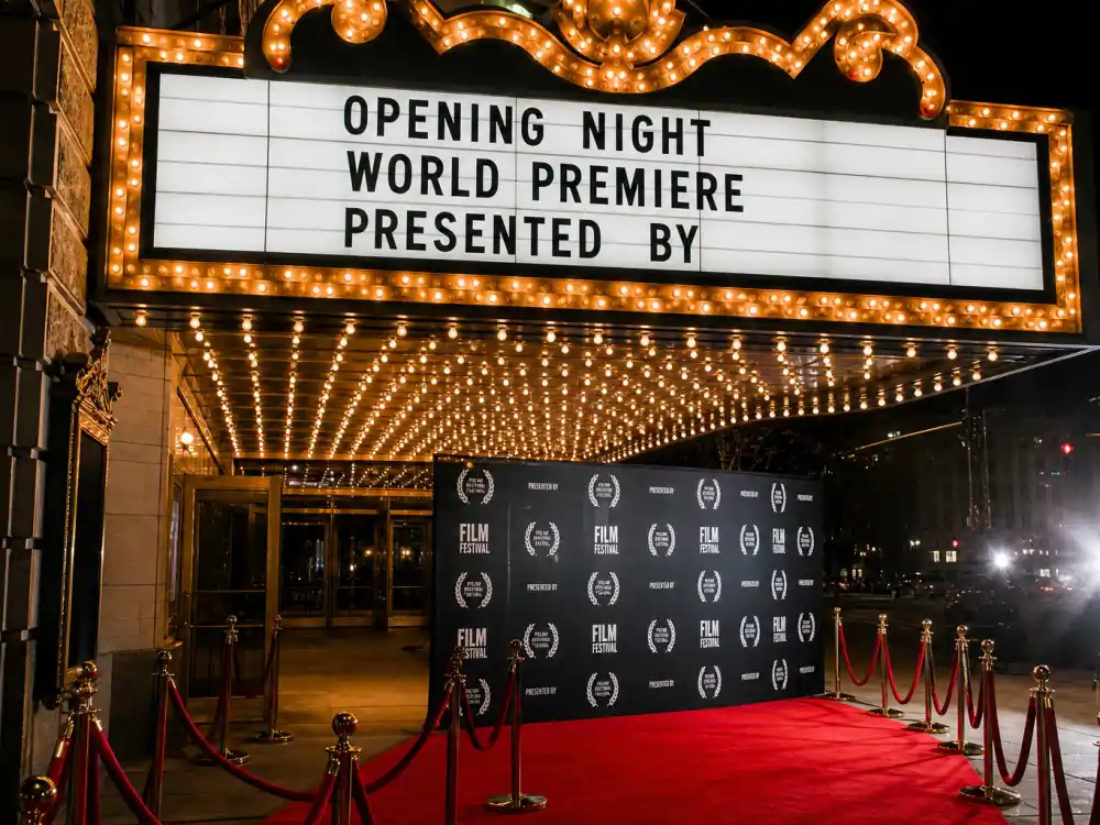 Theater marquee and film premiere display reflecting how old is Robert Downey Jr at industry peak — Oscar-winning milestones and blockbuster franchise dominance in his fifties and sixties