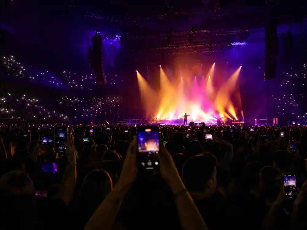 Arena concert stage seen from the audience — how old is Taylor Swift searches spike during global stadium tours and birthday seasons