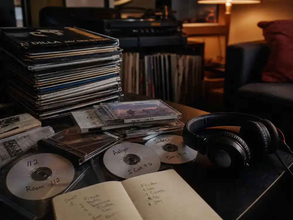 Vinyl records and burned mixtape CDs evoking how old is The Weeknd early underground era before Beauty Behind the Madness mainstream breakthrough