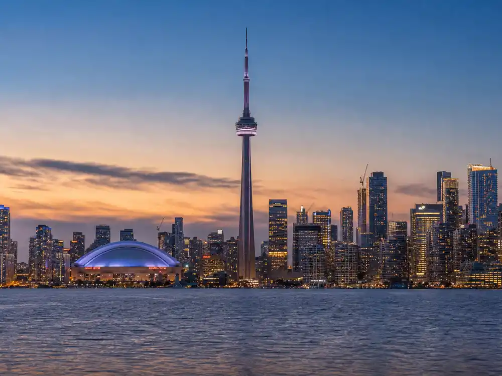 Toronto skyline at dusk evoking how old is The Weeknd birthplace — the Canadian city where Abel Tesfaye was born on February 16, 1990