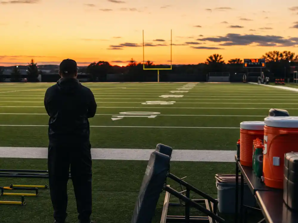 Football training field reflecting how old is Tom Brady career arc from Michigan quarterback to New England Patriots legend and seven-time Super Bowl champion