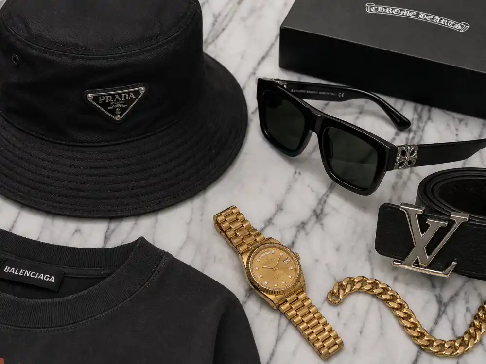 Bucket hat sunglasses and gold watch accessories completing how to dress like A$AP Rocky streetwear style finishing layer