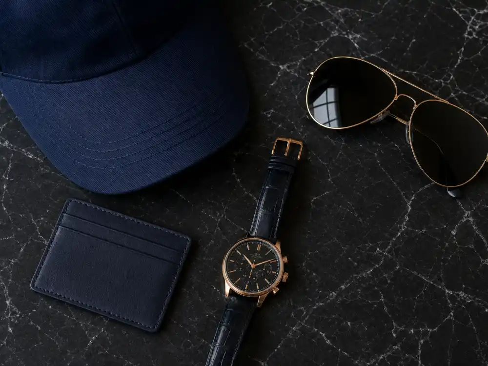 Watch aviator sunglasses and leather card holder defining how to dress like David Beckham smart casual accessory finish