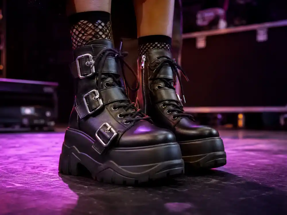 Chunky platform boots with silver buckles finishing how to dress like Dua Lipa stage style footwear layer
