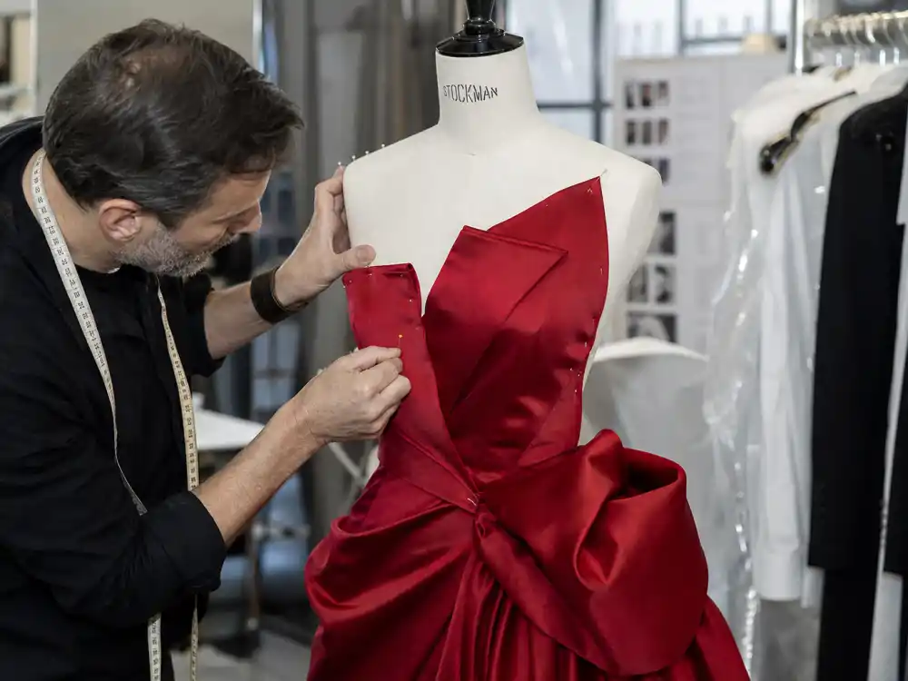 Tailor pinning structural couture bodice behind how to dress like Florence Pugh red carpet bold precision fit preparation