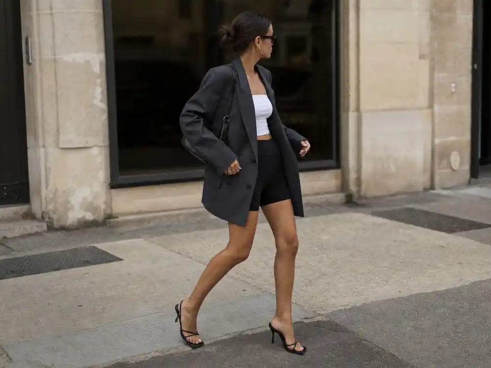 Oversized charcoal blazer with biker shorts showing how to dress like Hailey Bieber off duty blazer uniform