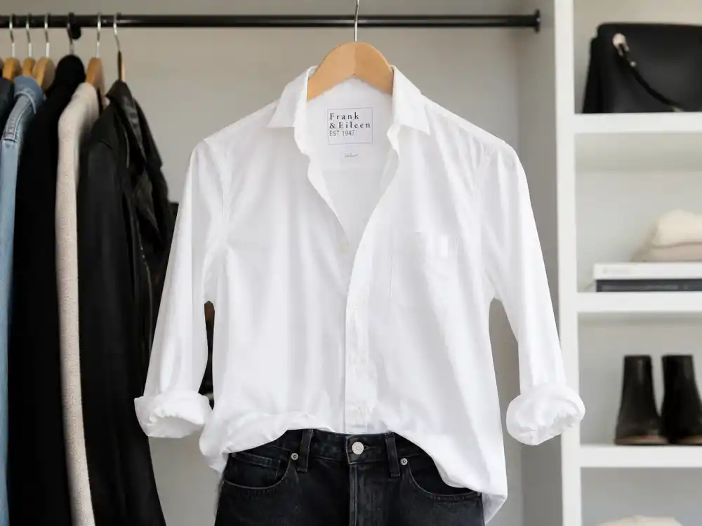 Crisp white button-down shirt showing how to dress like Jennifer Aniston classic style effortless shirt-and-jeans formula