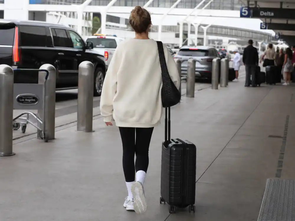Oversized cream sweatshirt central to how to dress like Kendall Jenner airport style comfort-first layering
