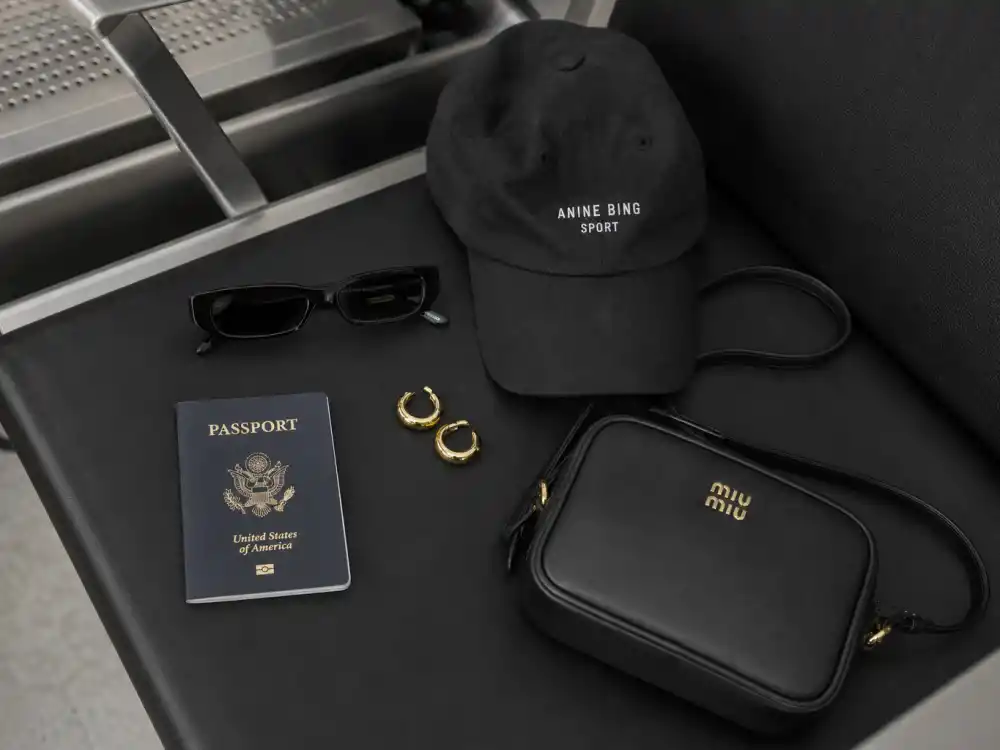Tiny sunglasses baseball cap and mini bag finishing how to dress like Kendall Jenner airport style accessory layer
