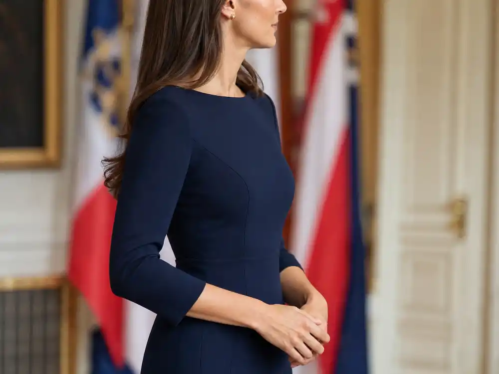 Navy sheath dress with three-quarter sleeves showing how to dress like Meghan Markle royal style occasion dressing