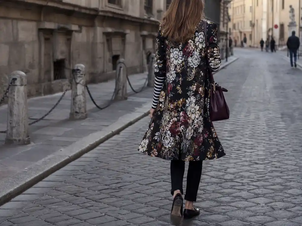 Tasteful striped knit and floral coat pattern mixing behind how to dress like Olivia Palermo street style eclectic chic
