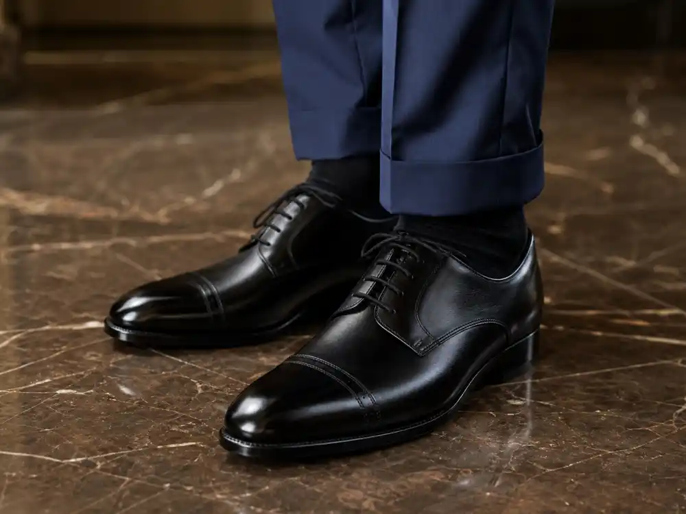 Polished black cap-toe Oxford shoes finishing how to dress like Ryan Gosling classic menswear formal footwear discipline