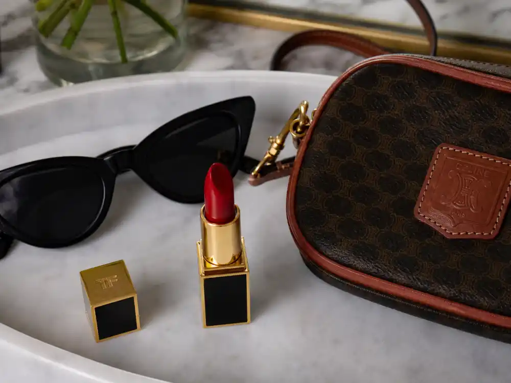 Classic red lipstick cat-eye sunglasses and vintage bag finishing how to dress like Taylor Swift casual accessory layer