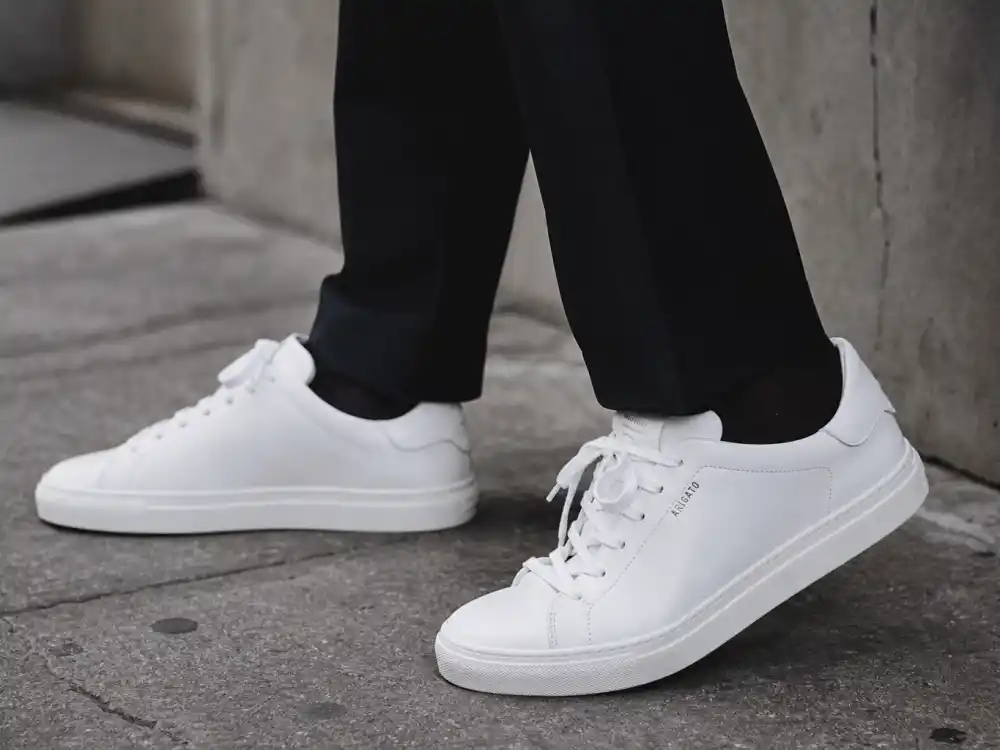 Designer sneakers with tailored trousers showing how to dress like Zendaya street style elevated casual formula