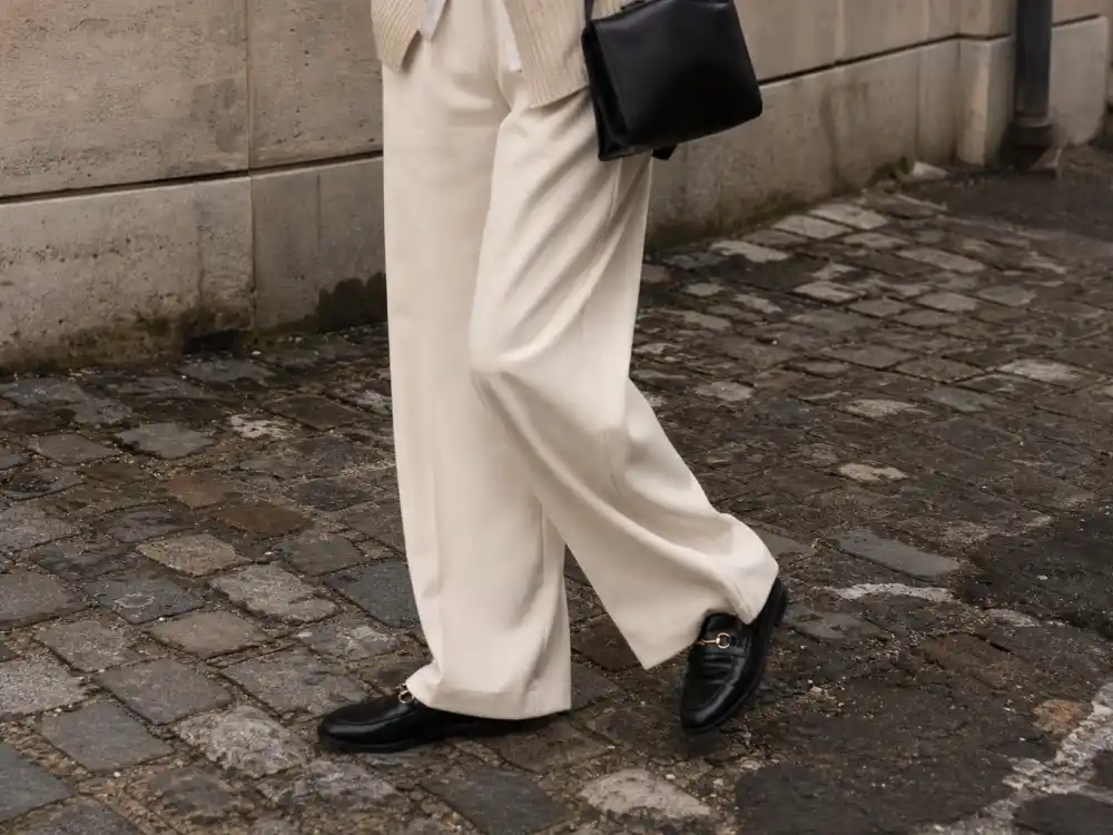 Wide-leg cream trousers and loafers illustrating how to dress like Zendaya street style proportion play