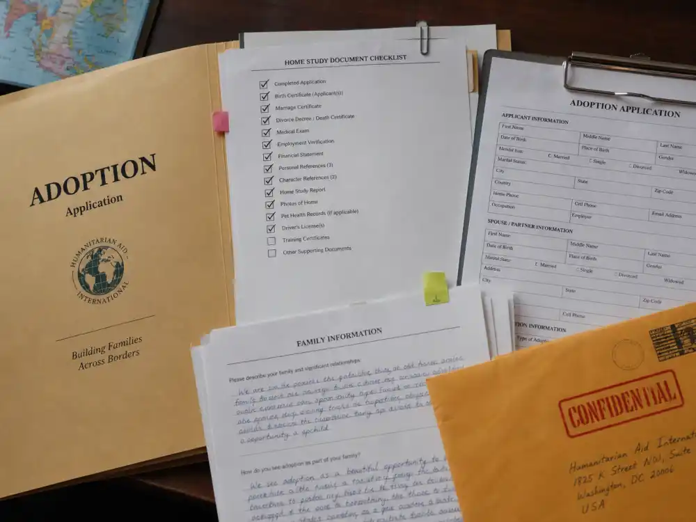 Open international adoption application folder for Hugh Jackman adoption journey explained — clipped forms and stamped envelope without identifiable faces