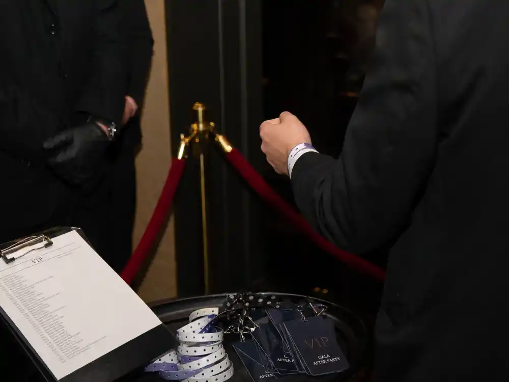 VIP wristband checkpoint — inside the Met Gala after parties, laminated lists and rope tiers separate dinner guests from plus-one after-party crowds