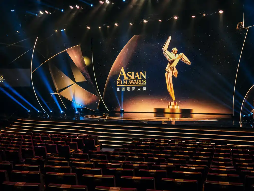 Asian Film Awards ceremony stage for international award shows Americans should know — Hong Kong auditorium with pan-Asian cinema trophy on golden LED backdrop