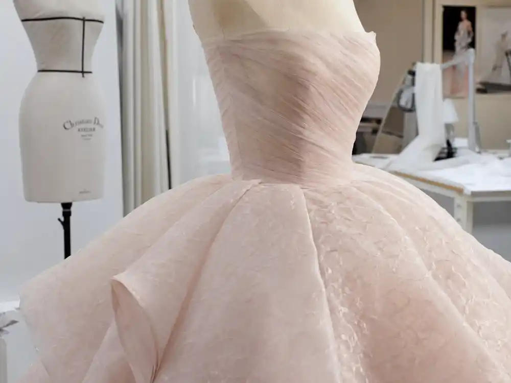 Christian Dior haute couture pale pink ball gown craftsmanship central to Jennifer Lawrence tripping Oscars dress construction and Raf Simons era