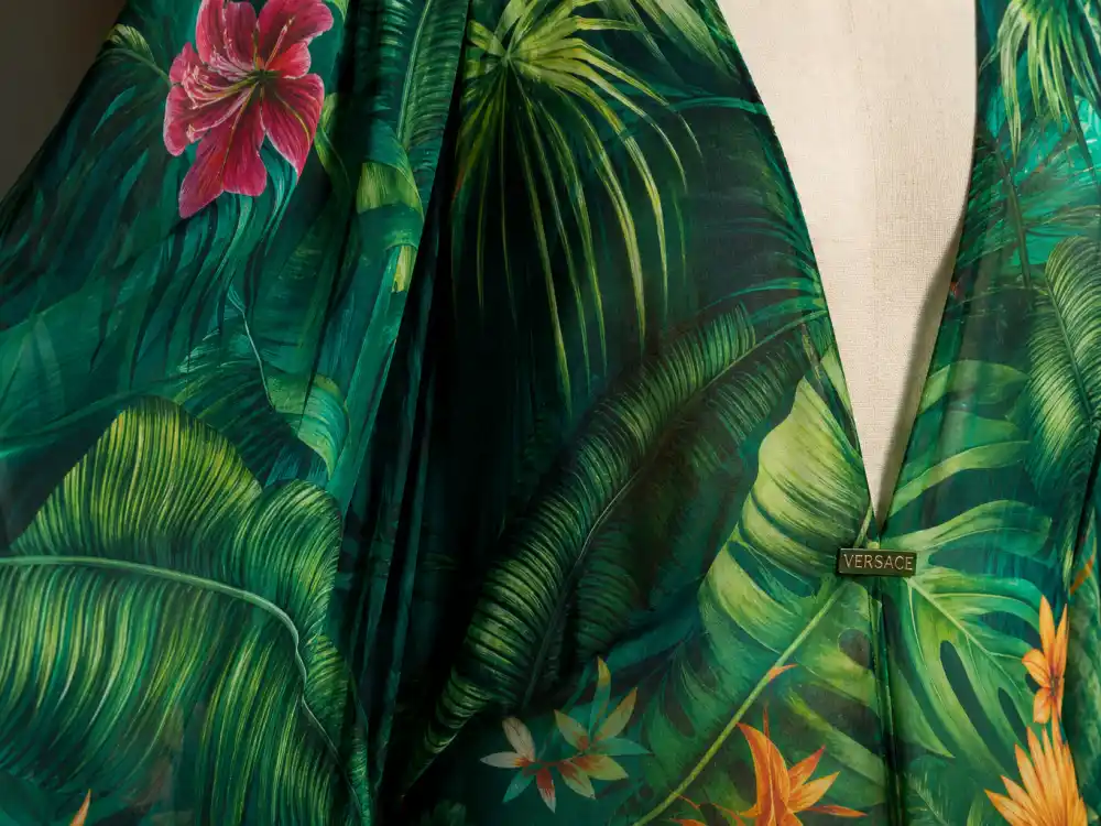 Tropical jungle palm-leaf print on emerald silk chiffon defining the Jennifer Lopez green Versace dress history textile signature