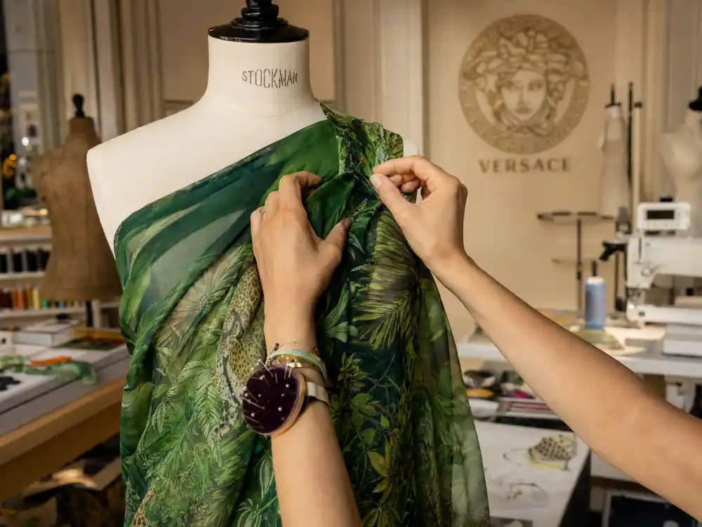 Versace atelier craftsmanship behind the Jennifer Lopez green Versace dress history — tropical print silk chiffon pinned on couture dress form
