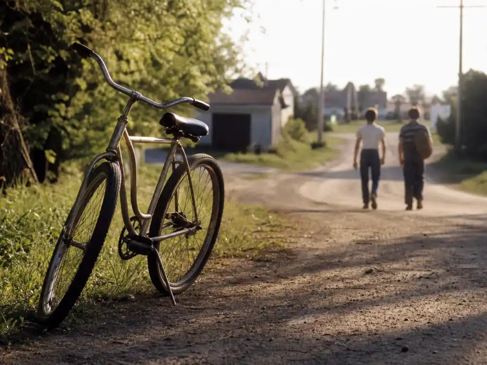 A vintage 1980s small-town dirt road with a bicycle evoking Jerry O'Connell Stand By Me child-actor breakthrough
