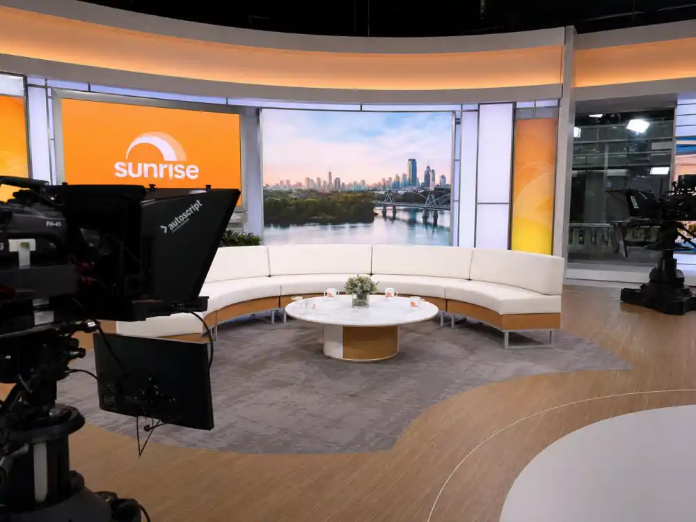 A bright daytime television studio couch set where Jerry O'Connell now works as a talk-show and game-show host