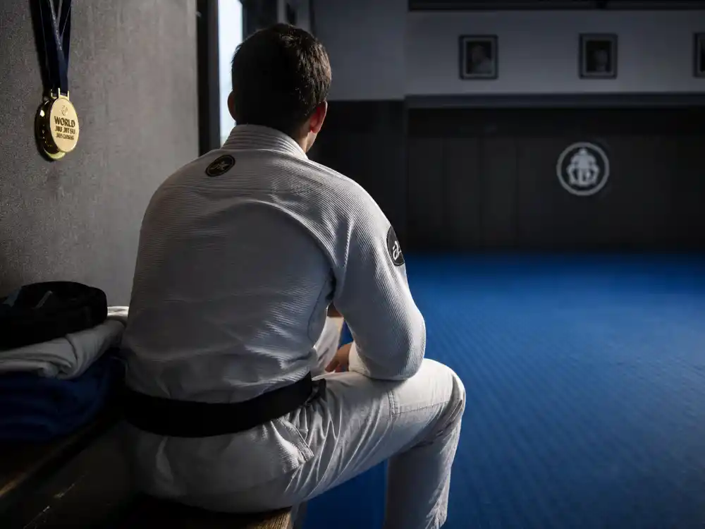 A Brazilian jiu-jitsu gym with blue mats representing Jonathan Lipnicki martial arts passion and competition