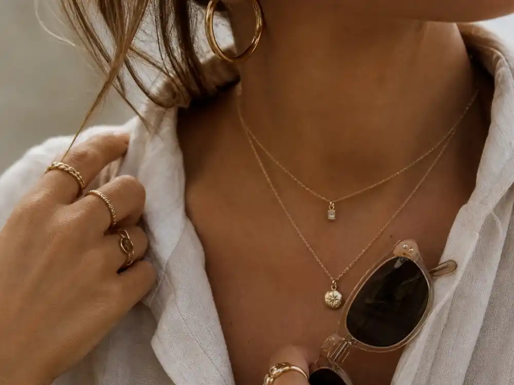 Gold hoops delicate chains and vintage sunglasses finishing Kaia Gerber model off duty style accessory elevation