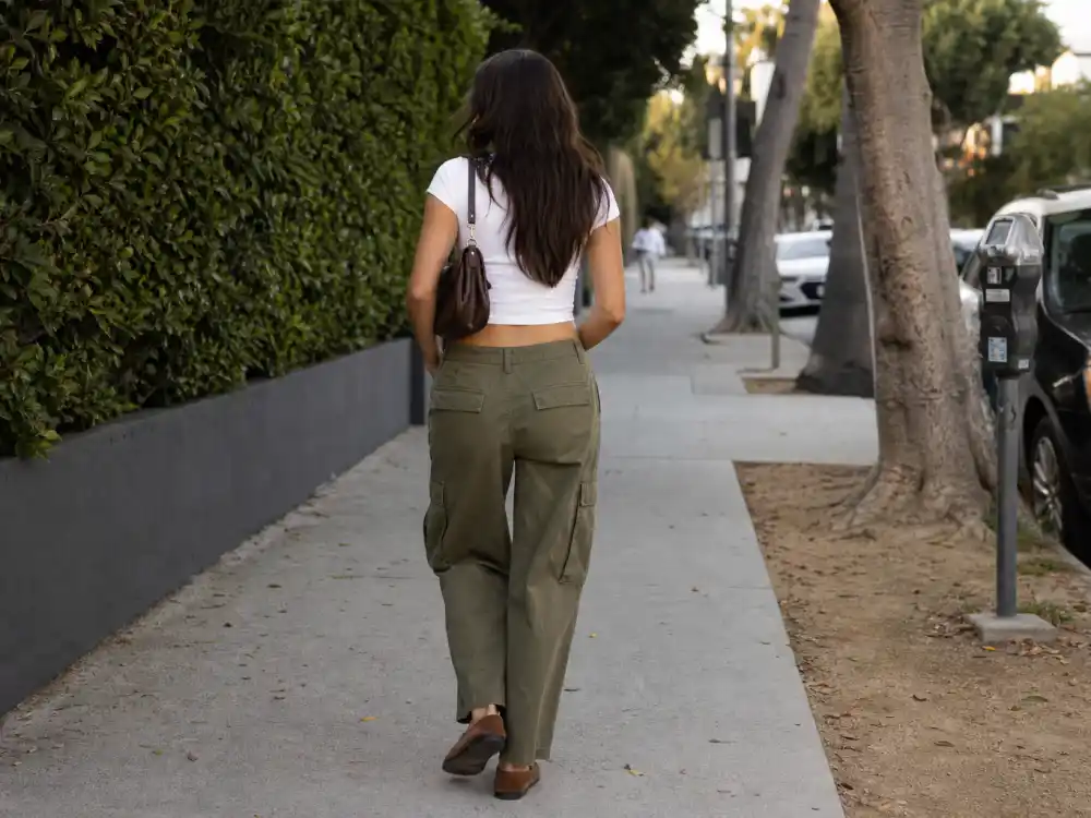 Olive cargos cropped white tee and suede loafers illustrating Kaia Gerber model off duty style casual chic rotation