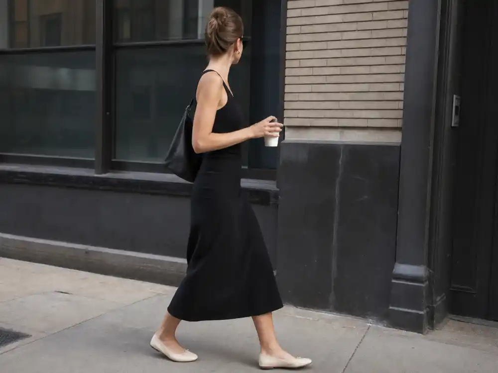 Black tank midi skirt and cream ballet flats defining Kaia Gerber model off duty style minimalist feminine codes