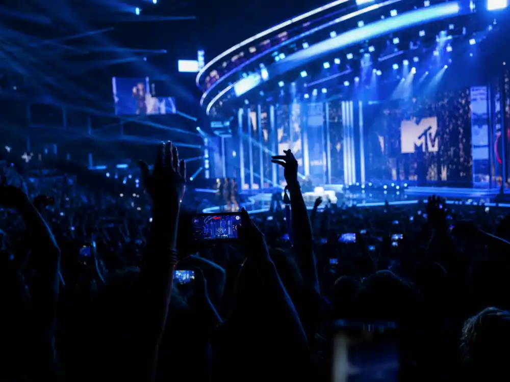 Arena audience silhouettes reacting during MTV VMA telecast capture shock at the Kanye West Taylor Swift VMA moment explained on live television