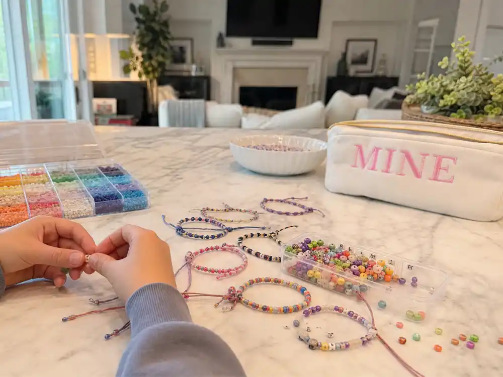 Friendship bracelets and bead craft supplies for Kardashian Jenner kids godparents and friends — cousin bond visual Khloe second mother Stormi without faces