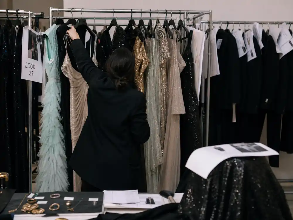 Walk-in closet with rolling racks of evening gowns and tailored pieces illustrating how Karla Welch celebrity stylist clients build red carpet wardrobes season after season