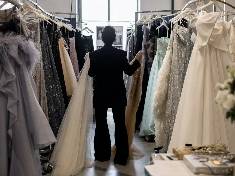 Designer showroom aisle with couture gowns on rolling racks — the sourcing lane where Karla Welch celebrity stylist clients discover emerging and established labels