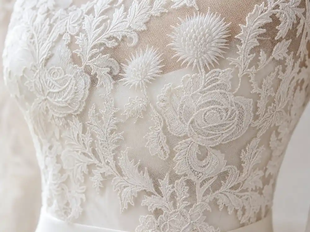 French Chantilly lace appliqué with rose and thistle motifs central to Kate Middleton wedding dress Alexander McQueen couture craftsmanship