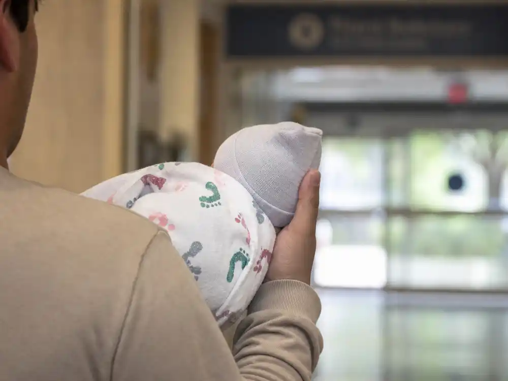 Hospital discharge hands holding newborn blanket for Keke Palmer pregnancy baby announcement — February 2023 son Leo birth per People and Us Weekly