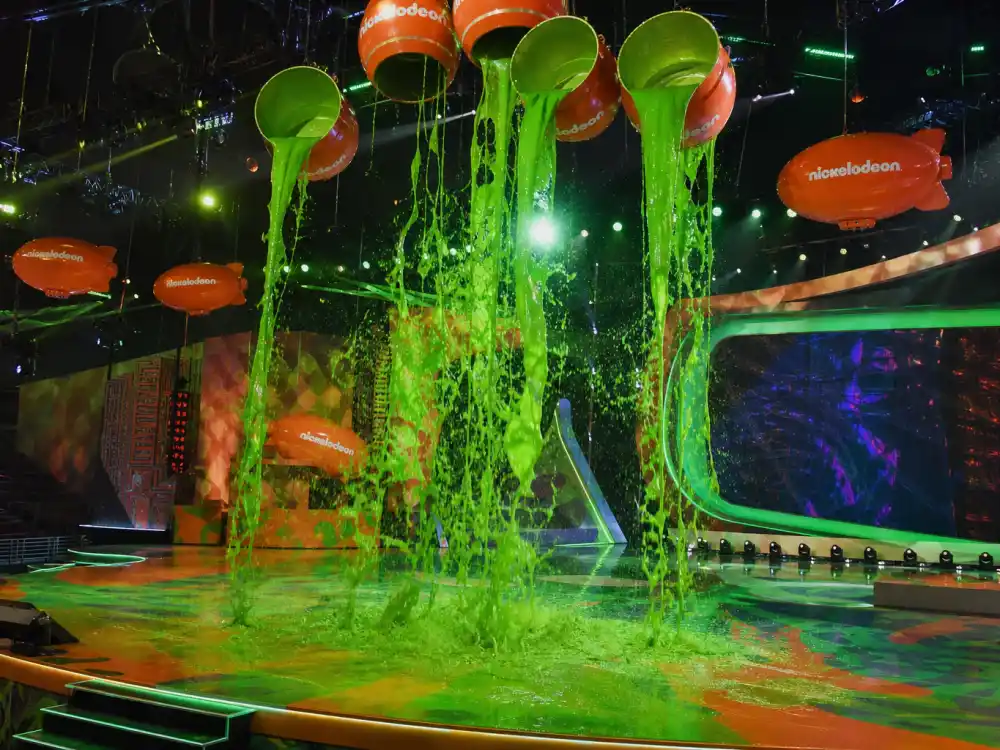 Green Nickelodeon slime pours on the awards stage where Kids Choice Awards 2026 winners list honorees celebrate after the November ceremony