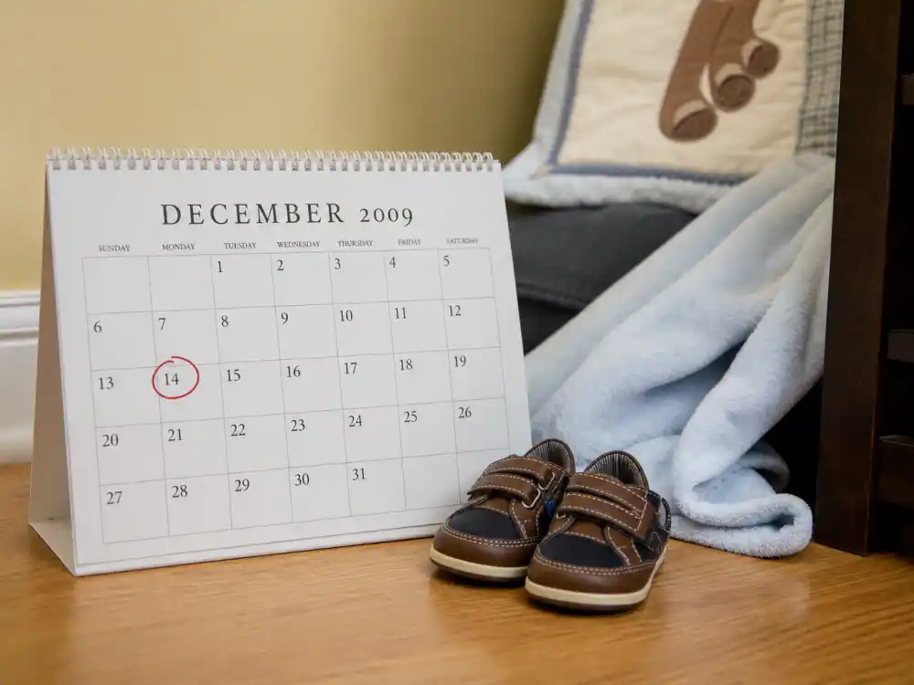 December 14 2009 calendar with baby shoes for Kourtney Kardashian kids Mason Penelope Reign — Mason Dash Disick birth date verified by People