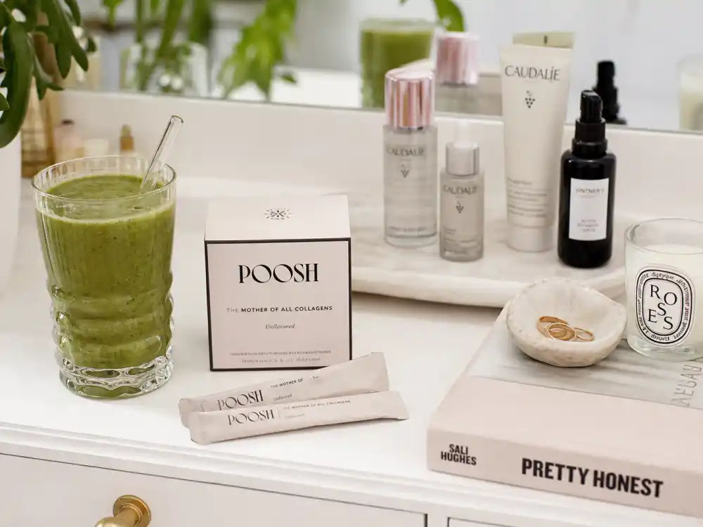 Poosh wellness products and clean beauty setup framing the Kourtney Kardashian pregnancy journey Barker health-first pivot after stopping IVF