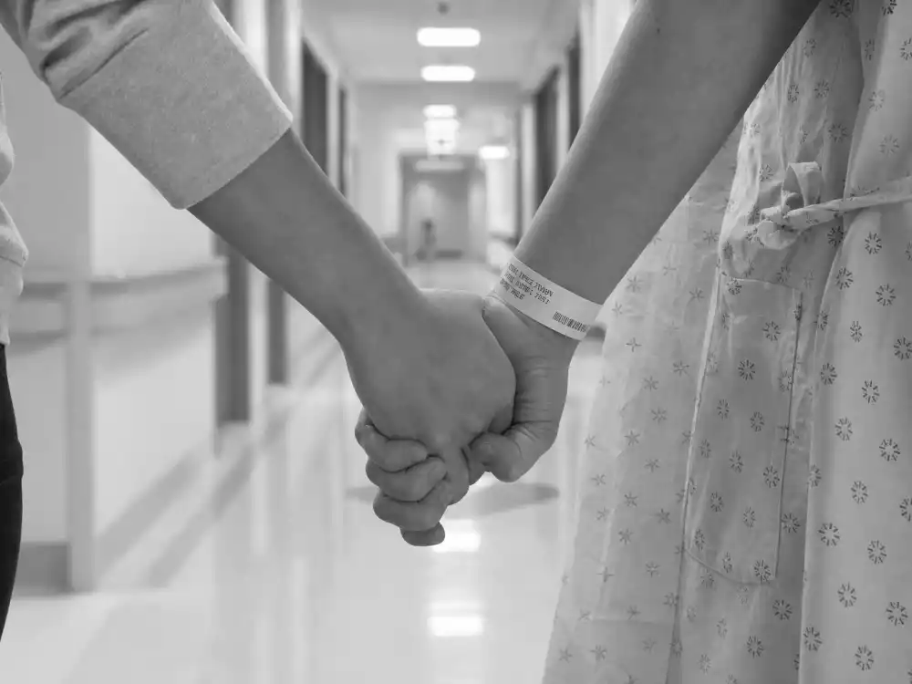 Hospital hand-holding scene for Kourtney Kardashian pregnancy journey Barker urgent fetal surgery September 2023 recovery verified by People